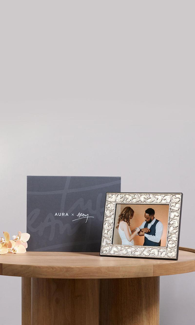 Aura Aram frame sitting on a side table showing a wedding couple