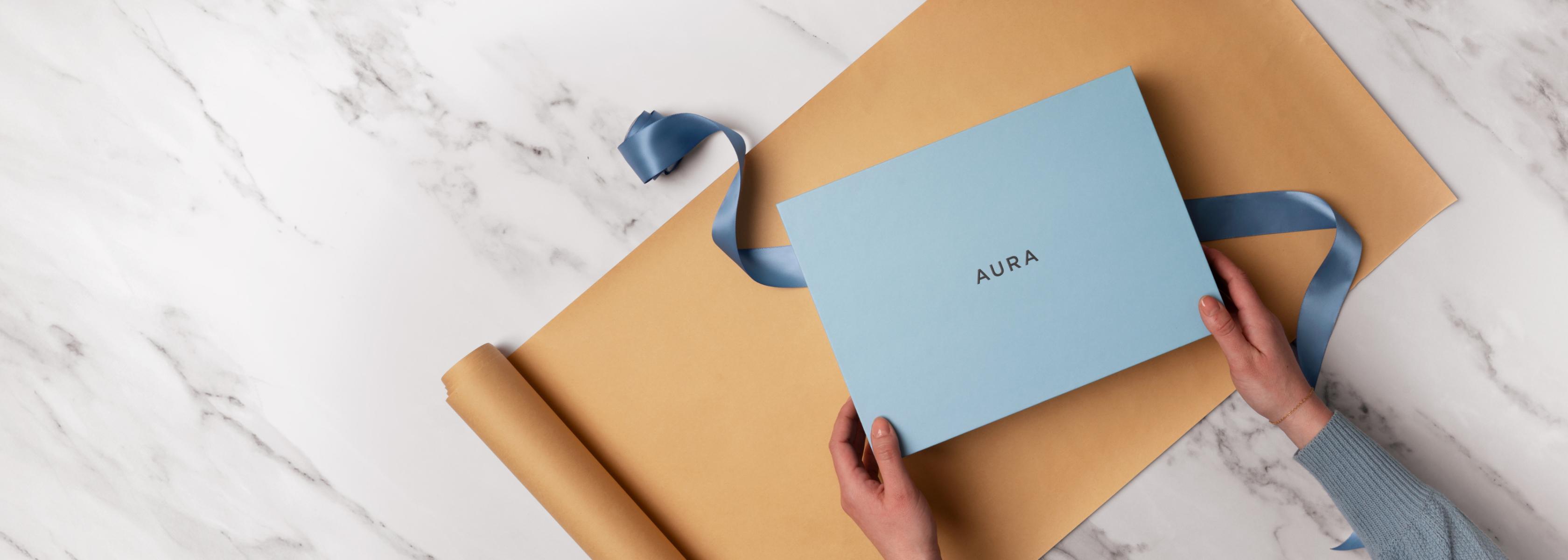 A blue Aura gift box with ribbon