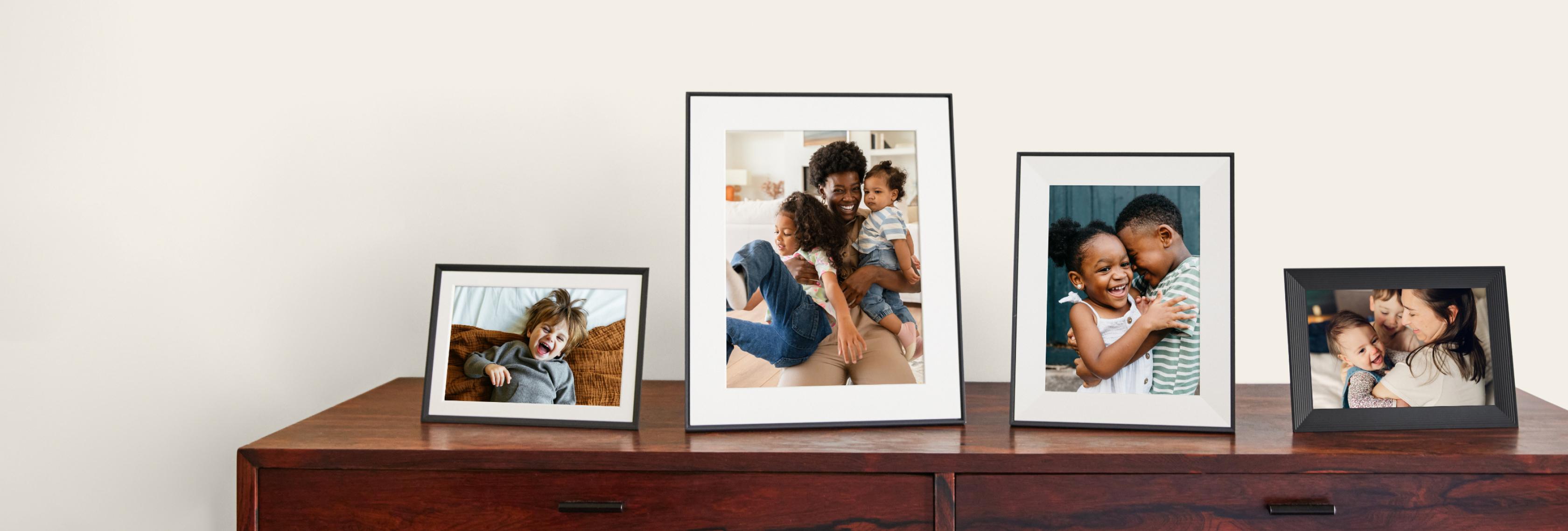 Four Aura frames displayed on a wooden cabinet