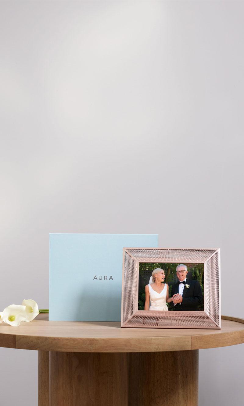 Aura Aram frame sitting on a side table showing a wedding couple